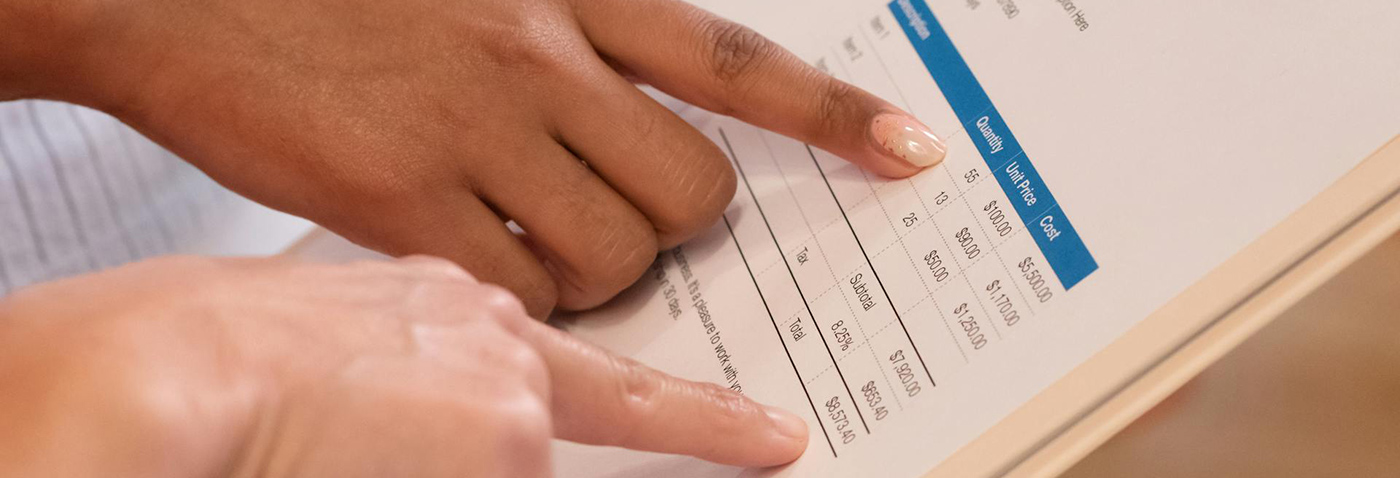 Graphic of a person analyzing an invoice closely, representing the importance of understanding invoice validity.